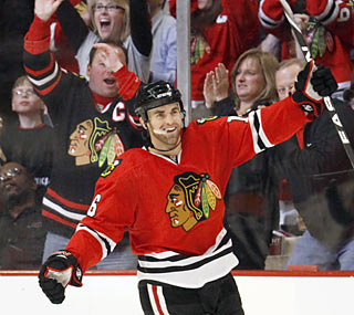 Andrew Ladd completes a hat trick in the third period, but it isn't enough to save the Blackhawks.  (AP)